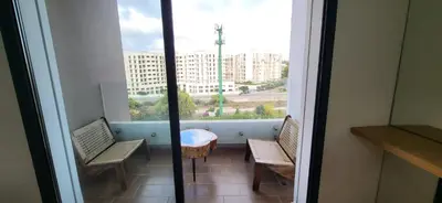 a balcony with two chairs and a table and a window at Le Cocon d'Oasis - Location journalière Casablanca in Casablanca
