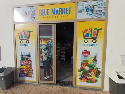 a store with three signs on the doors of a store at Bleu Beach uniquement pour famille in Sidi Rahal