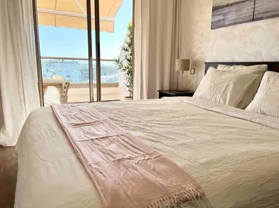 a bedroom with a large bed with a large window at DreamParc - Vue sur Mer et Parc Securite 24H in Mohammedia