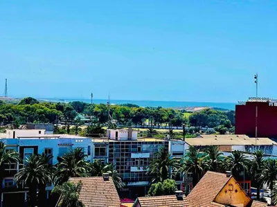 a view of a city with palm trees and buildings at DreamParc - Vue sur Mer et Parc Securite 24H in Mohammedia