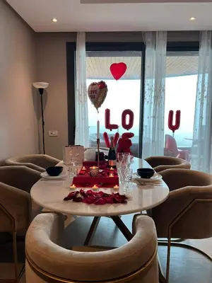 a table in a room with a love sign on the window at Marina Love in Casablanca