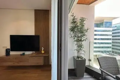 a living room with a tv and a large window at Marvelous Ocean View Suite Marina - By AppartAli in Casablanca