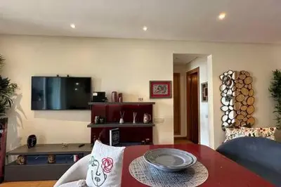 a living room with a table and a tv at Marina Urban Sea View - By AppartAli in Casablanca