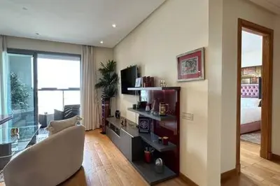 a living room with a chair and a room with a bed at Marina Urban Sea View - By AppartAli in Casablanca