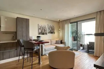 a living room with a couch and a table and chairs at Marina Urban Sea View - By AppartAli in Casablanca