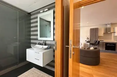 a bathroom with a sink and a mirror at Marina Urban Sea View - By AppartAli in Casablanca