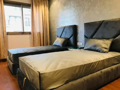 a bedroom with a large bed and a couch at THE luxurious and romantic pearl apartment in Mohammedia