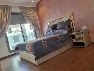 a bedroom with a bed with a olympics blanket at THE luxurious and romantic pearl apartment in Mohammedia