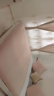 a bed in a room with a ceiling at superbe appartement en résidence balnéaire in Bouznika
