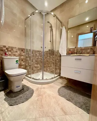 a bathroom with a shower and a toilet and a sink at superbe appartement en résidence balnéaire in Bouznika