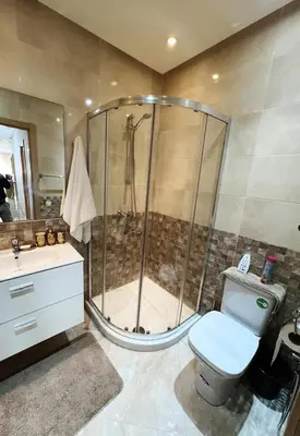 a bathroom with a shower and a toilet and a sink at superbe appartement en résidence balnéaire in Bouznika