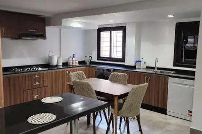a kitchen with a table and chairs in it at Villa Jack Beach in Tamaris