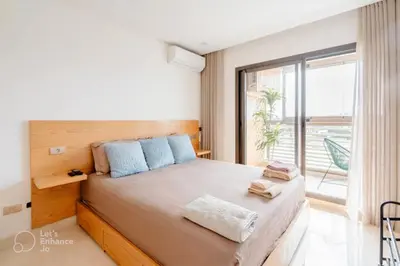 a bedroom with a large bed with a large window at StayInn - Studio luxueux & cosy avec terrasse aménagée in Casablanca
