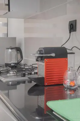 a red and black toaster sitting on top of a stove at TheCasaEdition Gauthier Residency City Center in Casablanca