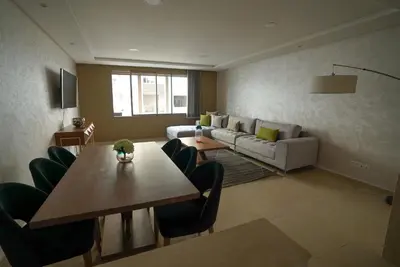 a living room with a table and a couch at New Appartment in Rabat