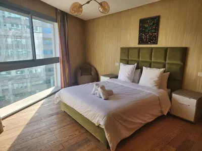 a teddy bear sitting on a bed in a bedroom at Casablanca Marina by Saloua in Casablanca