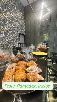 a table with many different types of pastries on it at TWENTY SIX ANFA LUXURY RESIDENCE by Shortstaymaroc -Hyper Centre -Parking in Casablanca