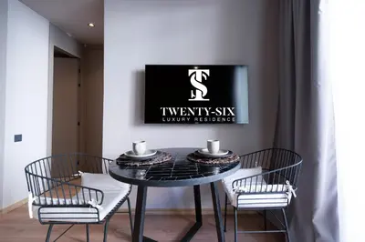 a dining room with a black table and three chairs at TWENTY SIX ANFA LUXURY RESIDENCE by Shortstaymaroc -Hyper Centre -Parking in Casablanca