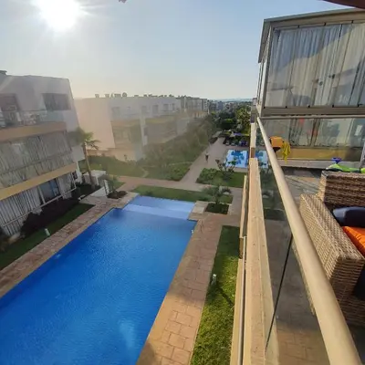 an overhead view of a swimming pool next to a building at Sidi Rahal Bleu Beach family in Sidi Rahal