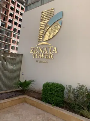 a sign on the side of a building at Zenata Tower in Casablanca