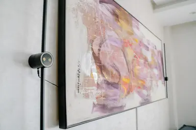 a painting hanging on a wall with a light at Best location, 2 minute to beach in Casablanca