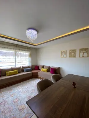 a living room with a couch and a table at Nouaceur Garden in Casablanca