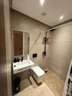 a bathroom with a sink and a toilet and a mirror at North Beach Plage & Confort in Mansouria