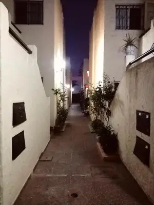 an empty alleyway in a building at night at Maison du bonheur in El Harhoura