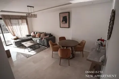 a living room with a couch and a table and chairs at New prestigia in Rabat