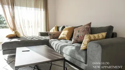 a living room with a couch and a coffee table at New prestigia in Rabat