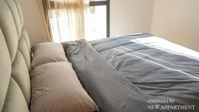 a bed sitting next to a window in a room at New prestigia in Rabat
