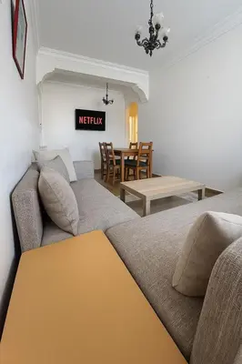 a living room with a couch and a table at Casablanca Beautiful and Tranquil Family Apartment in Casablanca