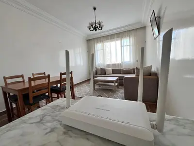 a living room with a laptop on a table at Casablanca Beautiful and Tranquil Family Apartment in Casablanca