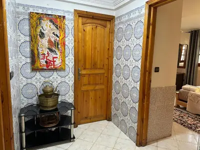 a room with a door and a painting on the wall at Rez-de-jardin à Mohammedia in Mohammedia