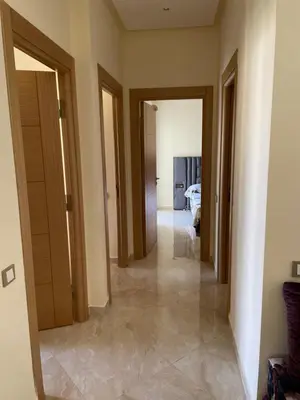 a hallway of a room with doors and a bedroom at Appartement à Casabay SidiRahal in Sidi Rahal