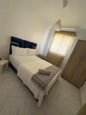 a bedroom with a large bed and a window at perle de bouznika 15min walking to the beach plus free unlimited WiFi in Bouznika
