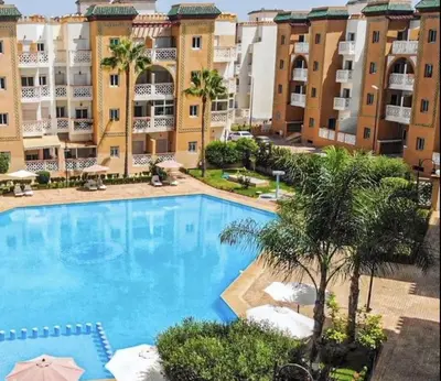 a large swimming pool in front of a building at Résidence Al Kawtar- Mansouria Mohammedia in Mohammedia