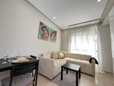 a living room with a couch and a table at Comfy & Modern Studio at blv Anfa in Casablanca