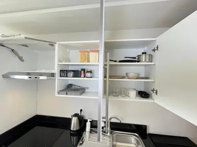 a kitchen with white shelves and a sink at Comfy & Modern Studio at blv Anfa in Casablanca
