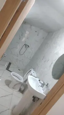 a bathroom with a toilet and a sink at Sweet Room Airport 5 in Deroua