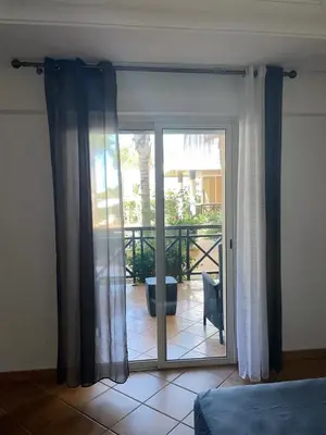 a bedroom with a sliding glass door to a patio at BOUZNIKA BAY COUNTRY CLUB in Bouznika