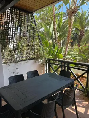 a black table and chairs on a patio at BOUZNIKA BAY COUNTRY CLUB in Bouznika
