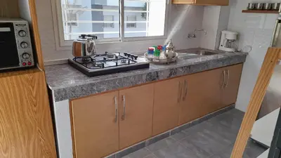 a kitchen counter with a stove and a sink at Tamesna HOUSE in Sidi Yahia az Zaʼer