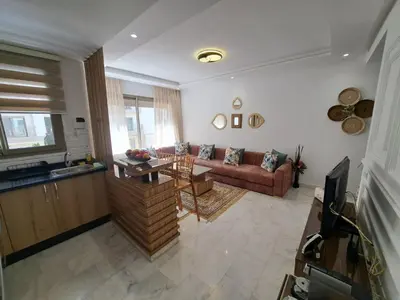 a living room with a couch and a table at Studio Casablanca aéroport nouaceur in Nouaceur