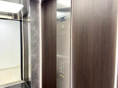 a wooden door with a control panel in a bathroom at Eden Luxury Anfa-Big Apt 3 Bedrooms/Massira Avenue in Casablanca