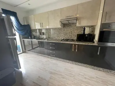 a kitchen with stainless steel cabinets and a counter top at APPARTEMENT HAUT STANDING proche gare casa voyageur in Casablanca