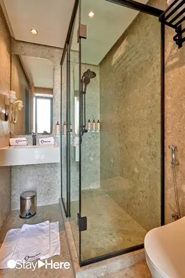 a bathroom with a glass shower and a sink at Stayhere Casablanca - Maarif - Elite Residence in Casablanca