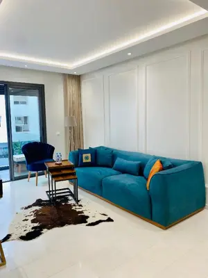 a blue couch in a living room with a table at Atlantic Suite View 3 in Casablanca