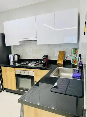 a kitchen with white cabinets and a sink at Atlantic Suite View 3 in Casablanca