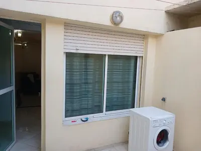 a house with a window with a washing machine at Appartement Casa Voyageurs in Casablanca